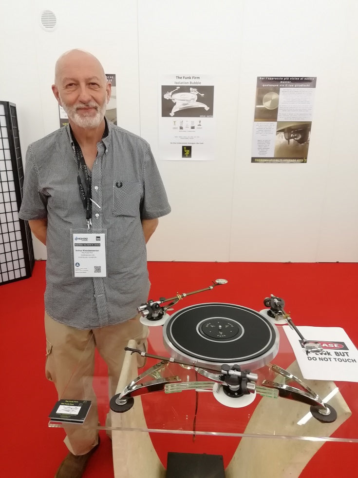 Arthur Khoubesserian beside a Funk Firm turntable at a hi-fi show.